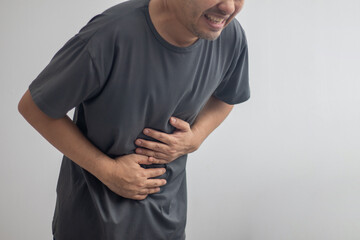 man having abdominal pain on white background