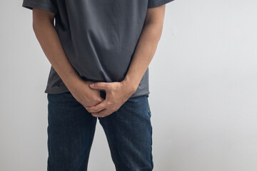 The man touched the crotch of his pants with pain.