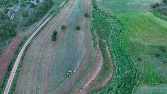 Tractor working in the agricultural landscape of Hortigüela. Aerial view from a drone. Arlanza Valley. Burgos, Castilla y Leon, Spain, Europe