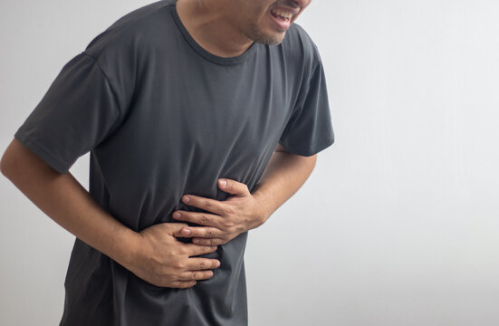 man having abdominal pain on white background