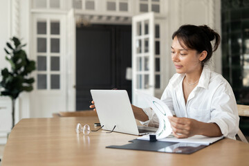 Enjoying her work online, a female manager in the office is doing a job assignment.