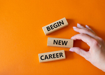 Begin new career symbol. Concept word Begin new career on wooden blocks. Businessman hand. Beautiful orange background. Business and Begin new career concept. Copy space