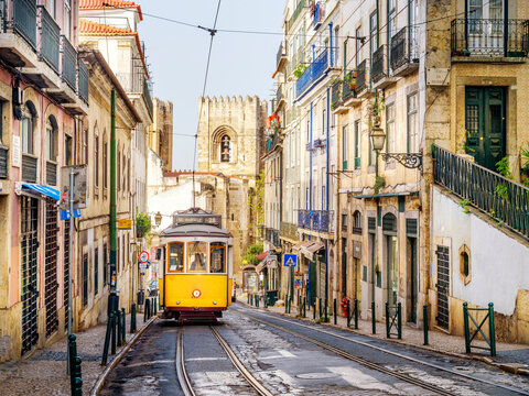 Hist&mdash;ric  Alfama District , Street Scene.with yellow Vintage Tram Number 28...Lisbon, Portugal ,Europe
