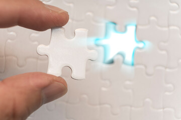 Hands with jigsaw puzzle pieces, Business strategy planning, Alzheimer's disease, Autism and mental health concept