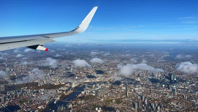 Window seat overlooking the down town area of London city the eye 30fps 4k slow downward tilt