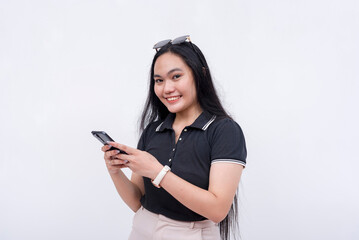 Naklejka premium A young woman holding her cellphone with both arms. A modern lady employee. Communication and app concept. Isolated on a white backdrop.