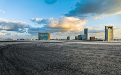 Empty asphalt road and modern city skyline with buildings at sunset in Ningbo, Zhejiang Province,...