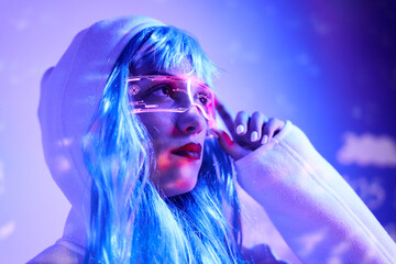 Futuristic woman adjusting transparent goggles with virtual screen