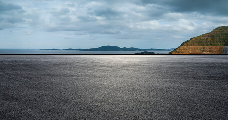 Asphalt road and mountain with sea natural landscape on a cloudy day