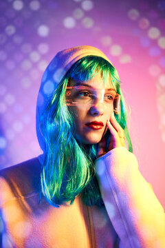Futuristic woman adjusting transparent goggles with virtual screen
