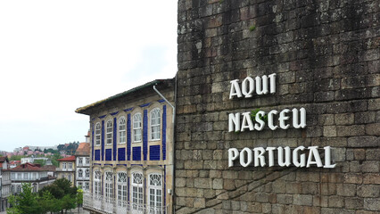 Cityscape of Guimaraes, Portugal - Wall with the inscription "Aqui Nasceu Portugal" (Here Portugal was born in English)

