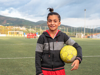 Smiling boy with soccer ball on field