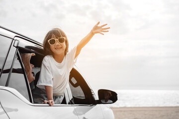 Fototapeta na wymiar Hatchback Car travel driving road trip of family summer vacation in car at sunset,Girls happy traveling enjoy holidays and relaxation together get the atmosphere and go to destination