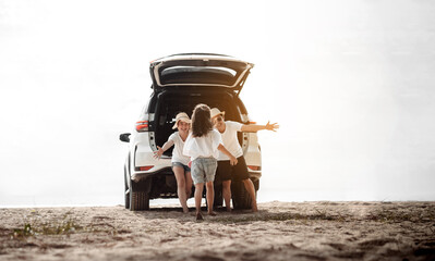 Obraz na płótnie Canvas Family travel car road trip concept. summer vacation in car in the sunset, Dad, mom and daughter happy traveling enjoy and relaxation together driving in holidays, people,lifestyle with transportation