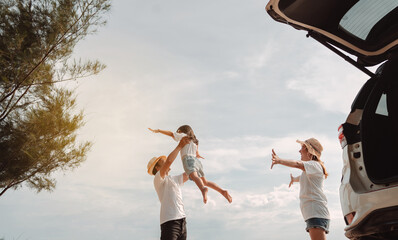 Happy Family with car travel road trip. summer vacation in car in the sunset, Dad, mom and daughter...