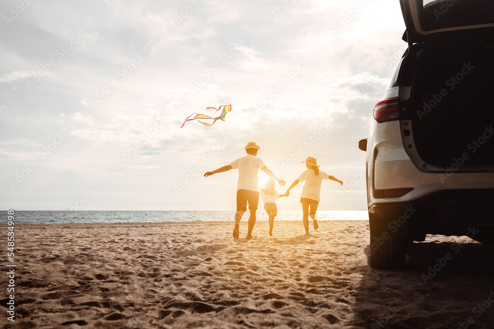 Wall mural happy family with car travel road trip. summer vacation in car in the sunset, dad, mom and daughter 