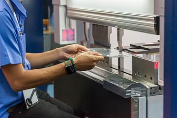 The skill operator working with hydraulic press brake bending machine.