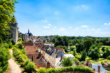 View of the Beautiful Village of Montresor, Loire, France, with St John the Baptist Collegiate Church and Towers of Montresor Castle - obrazy, fototapety, plakaty