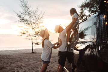 Family with Car travel driving road trip summer vacation in car in the sunset, Dad, mom and...