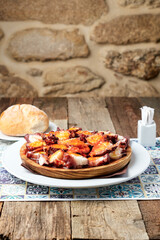 Plate with octopus and a piece of bread, vertical image