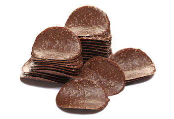 Pile of cripsy dark chocolate wave chips isolated on white