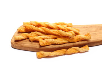 Butter pastry twists with emmental cheese and cheddar cheese on chopping board isolated on white