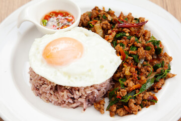 Rice with stir fried minced pork and basil topped with fried egg, Thai food called Pad Ka Prao Moo