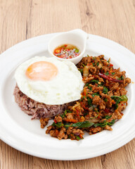 Rice with stir fried minced pork and basil topped with fried egg, Thai food called Pad Ka Prao Moo