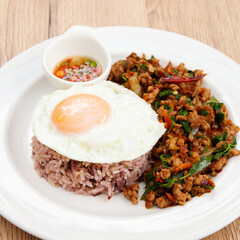 Rice with stir fried minced pork and basil topped with fried egg, Thai food called Pad Ka Prao Moo