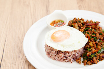 Rice with stir fried minced pork and basil topped with fried egg, Thai food called Pad Ka Prao Moo