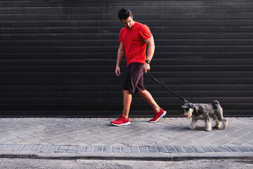 Sportsman walking on street with dog