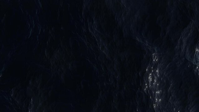 Aerial view of the dark ocean. Ripples and waves on deep water surface.  Turbulent sea reflects the bright moonlight. Soft and relaxing movement. Night top view. Liquid background.