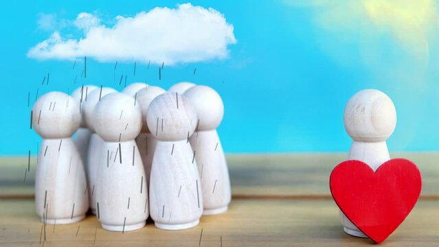 Group of wooden figures standing in the rain and one is standing in the sun holding a heart
