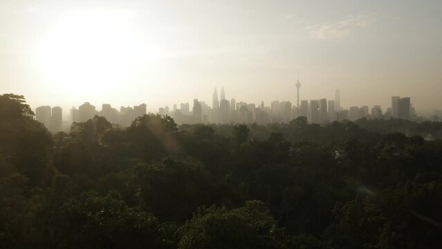 landscape view of kuala lumpur city center downtown district area with many skyscraper building highrise modern style towers with beautiful vanilla sundown sunrise