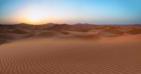 Beautiful sand dunes in the Sahara desert with amazing sunset sky - Sahara, Morocco