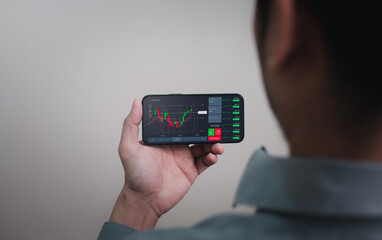 business man using his mobile phone or smartphone application for trading cryptocurrency or stock exchange