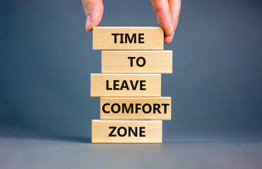 Leave comfort zone symbol. Concept words Time to leave comfort zone on wooden blocks. Businessman...