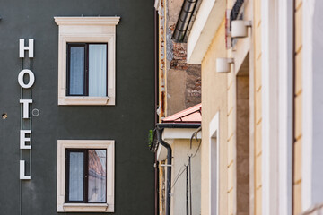 Naklejka premium Exterior of a hotel with sign letters on grey wall. Vacation building architecture in Europe