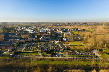 Cemetery and residential area along the Scheldt river, in Wichelen, Belgium