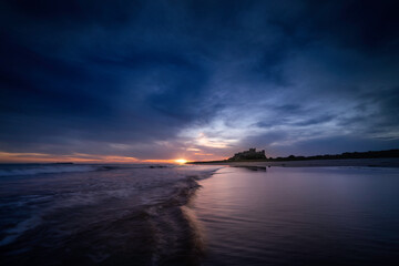Bamburgh castle viewed at sunrise, located on the northumberland coastline.