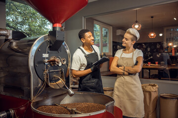 Obraz na płótnie Canvas Joyous coffee roasters in a work environment