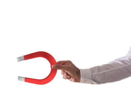 Hand holds a big red magnet. concept of attraction