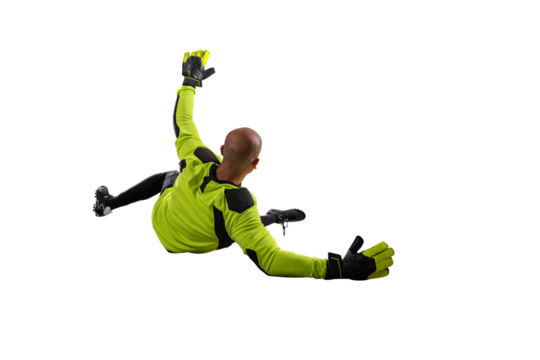 Soccer goalkeeper jumps to defend his team during a football game