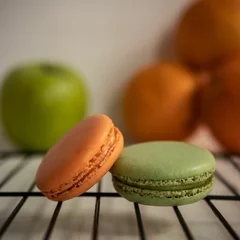 Sierkussen Close-up view of orange and green sweet French macarons on the baking rack © Pjm Captures/Wirestock Creators