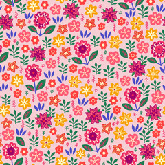 Amazing seamless floral pattern with bright multicolored flowers and leaves on a soft pink background. An elegant template for fashionable prints. Modern floral background. Folk style