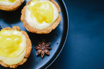 Baked pineapple cupcakes. black background with yellow cakes