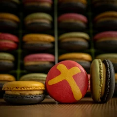Fotobehang Colorful French macarons with cross design - Holiday sweets © Pjm Captures/Wirestock Creators
