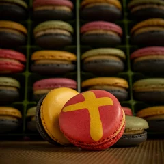 Fotobehang Colorful French macarons with cross design - Holiday sweets © Pjm Captures/Wirestock Creators