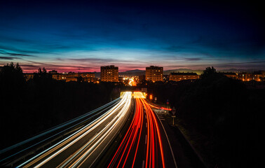 Rays of lights, in slow motion, of cars driving on the highway at night to enter and leave the city of Granollers, Barcelona.