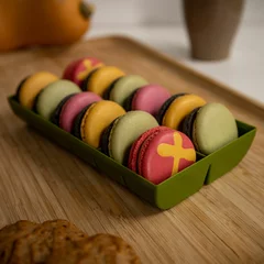 Keuken foto achterwand Colorful French macarons in a box over the wooden surface - Holiday sweets © Pjm Captures/Wirestock Creators